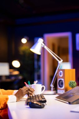 Evden çalışan serbest çalışan, dizüstü bilgisayarda klavye kullanan, belge yazan biri. Not defterindeki tuşlara basarak, iş arkadaşlarına e-posta gönderirken yakın plan çekimini yap