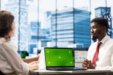 İK çalışanı, yeşil ekran dizüstü bilgisayar kullanarak şirket için çeşitlilik toplama stratejisi uyguluyor. Acemi er, Afrika kökenli Amerikalı bir adamla sahte defter kullanarak anlaşmaya vardı.