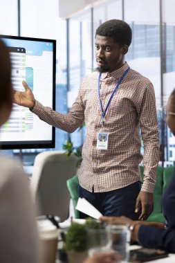 Çeşitli çalışma ekipleri interaktif kurulda dijital pazarlama eğilimlerini tartışıyor, analitiği kullanarak bir toplantıda satış rakamlarını artırıyor. Girişim şirketi kuran iş uzmanları.