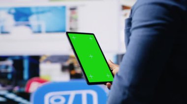 Dijital arayüzler ve multimedya görsellerinin yanındaki krom anahtar ekrana bakan Afrikalı Amerikalı teknoloji meraklısı, içerik oluşturma, mobil teknoloji ve küresel çevrimiçi etki sergiliyor. Kamera B.