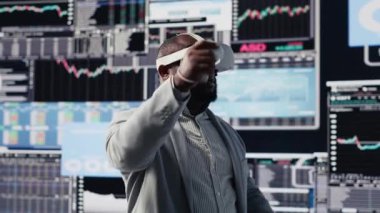 Fon elde etmek için sanal gerçeklik kulaklığıyla çalışan iş lideri, kalkınma planı için ön gösterge panellerindeki performans raporlarını gözden geçiriyor. Maddi durumu analiz etmek için 3D simülasyon. Kamera B.