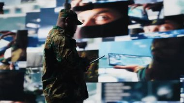 Afrika kökenli Amerikan askeri komuta merkezinde uydu gözetleme verileriyle çalışır. Ulusal savunma görevinde taktik ve savaş planlaması için istihbarat toplar. Silahlı kuvvetler. Kamera B.