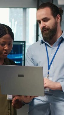 Yapay zeka sistem ölçümlerini inceleyen, performans gösterge panellerini izleyen dikey video çalışan programcılar. Bilgisayar ve kamera A 'daki araçları kullanarak sinirsel ağları ayarlayan teknoloji şirketinin iş arkadaşları.