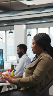 Performans ve tahminleri optimize etmek için yapay zeka kullanan dikey video kadın yazılım geliştiricisi. Ofis eğitim makinesindeki kadın modelleri bilgisayar, kamera A kullanarak öğreniyor.