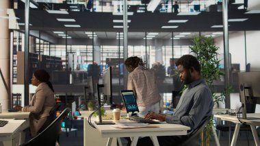 Karar vermek için bilgi ve performans ölçümleri üzerinde çalışan analist, proje hedeflerine odaklandı. Yönetici asistanı iş görevlerini yönetir ve verileri gözden geçirir, uzmanlık gösterir. Kamera B.