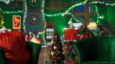 Noel ağacı renkli çelenklerle dolu ve Noel Baba çantasının yanında asılı duran toplar hediye dolu. Noel Baba 'nın boş atölyesinde Noel malzemeleriyle dekore edilmiş tuhaf bir şenlik havası var.