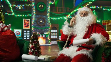 Noel Baba telefona cevap veriyor, hediye isteyen çocuklara cevap veriyor. Noel Baba 'yı taklit eden kişi çocuklarla Noel hediyeleri hakkında konuşuyor sabit telefon ve kamera A' yı kullanıyor.