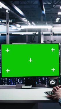 Dikey video sunucu teknisyeni yeşil ekranda yapay zeka kullanarak tanıları gözden geçiriyor. Veri merkezinde bilişim işçisi, krom anahtar bilgisayarda yapay zeka kullanarak performans verilerini analiz ediyor.