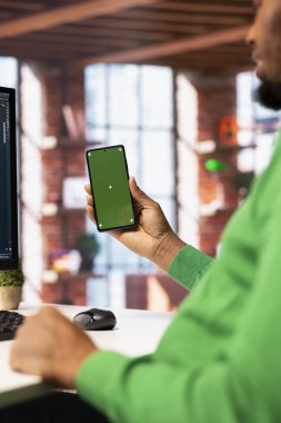 İzole edilmiş cep telefonunu arkadaşlarına mesaj atmak için kullanan bir adam. Krom anahtar cep telefonu kullanarak sosyal ağ internet sitesinden arkadaşlarla konuşan kişi, kapat