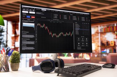 Oturma odasındaki bilgisayar ekranında hisse senedi alıp satmak için kullanılan ticari yazılım arayüzünü görüyorsunuz. Yatırım yapan borsa grafiklerini gösteren web sitesi UX 'in PC ekranını kapat