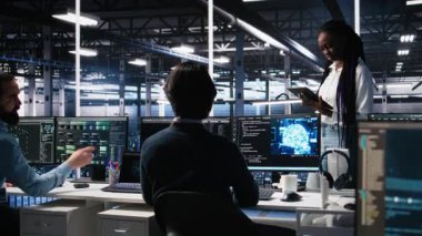 Yüksek teknoloji veri merkezindeki teknisyenler sinirsel ağ yazılım geliştirme konusunda işbirliği yapıyorlar. Sunucu merkezi IT çalışanları konuşuyor, PC, kamera A kullanarak derin öğrenme teknolojisi uyguluyorlar.