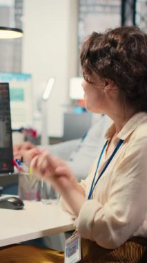 Dikey Video İş kadını, bir hissedarla İnternet sohbet etkinliğine katılarak, bir brifing için performans ölçümleri hakkında görüşlerini paylaşıyor. İş ortakları arasında ofiste video konferansı