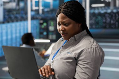 Sunucu odasındaki sistem yöneticisi veri yedekleme çözümlerini uygulamak ve yönetmek için dizüstü bilgisayar kullanıyor. Veri Merkezi IT uzmanı teknik hataları tespit edip çözümler, verimli bir iyileşme sağlar