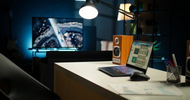 Konforlu çatı katı tarzı aydınlık bir daire ve modern bir ofis. Alanda ahşap mobilyalar, dekoratif bitkiler ve işlevsel çalışma alanıyla şık iç tasarımı birleştiren bir televizyon bulunuyor..