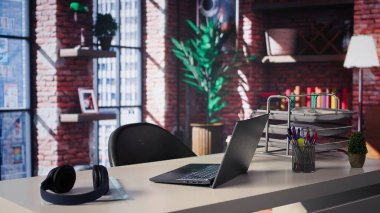 Panoramik pencereler ve şık mobilyalarla çevrili lüks bir ev ofisinin açık masası. Modern tasarım, çalışma ve yaratıcılık için mükemmel geniş bir sanatsal ortam yaratıyor..