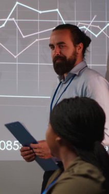 Vertical Video Diverse kurumsal danışmanları ilerideki projelerde çalışmak için geri bildirimleri ve hedefleri değerlendiriyor, gece toplantılarında bir plan ve strateji geliştiriyor. Karanlık ofisteki iş ortakları