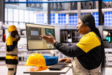 Akıllı fabrika mühendisi otomatikleştirilmiş montaj hattını bilgisayarı kullanarak, robotik kol hareketlerini optimize ederek ve üretimdeki taşıyıcı verimliliğini kullanarak takip ediyor. Profesyonel teknisyen sektör 4.0 yazılımını inceledi.