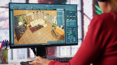 Kadın çalışan, binanın içini mimari yazılım ve planlarla 3D olarak tasarlıyor. Döşemeyi kişiselleştirmek için bilgisayar destekli araçlar ve modeller kullanır. Kamera A.
