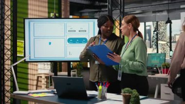 Profesyonel kadınlardan oluşan işbirlikçi ekip anahtar veri ve raporları incelerken, iş büyümesine yönelik strateji belirliyor, içgörüleri kalkınma hedefleri ve takım çalışmalarına göre sıralıyor. Ağ kurmak. Kamera A.