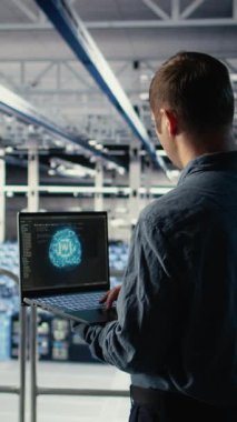 Dikey Veri Merkezi sistem yöneticileri, en uygun fonksiyona göre ayarlanan nöral ağların yapılandırılmasını araştırıyorlar. Sunucu merkezi çalışanları, derin öğrenme hatası raporlarını kontrol etmek için laptop kullanır, kamera