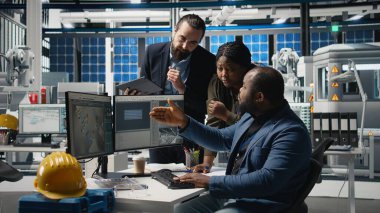 Siyah endüstri mühendisleri üretim denetimi sırasında güneş paneli sistemleri üzerinde birlikte çalışarak mühendislik doğruluğu, kalite kontrolü ve fabrika işletim verimliliğini sağlıyorlar. Kamera A.