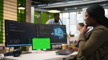 Yapay zeka algoritmalarını kodlamak, yazılım sorunlarını çözmek ve sistem istikrarını iyileştirmek için izole ekran tableti kullanan yönetici. Krom anahtar aygıtı, yapılandırma ayarları, kamera A kullanarak teknik başlatma ofis çalışanı