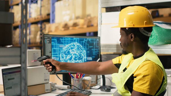 Black worker scanning to register shipping labels tracking info with AI brain, package tracking software helps handling online shopping orders with neural networks automation. Camera B.