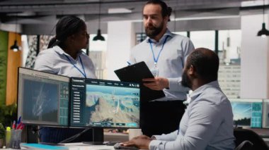 Ofisteki mühendisler yeşil enerji üretim teknolojisi testi yapıyorlar. Takım çalışma arkadaşları yenilenebilir enerji sektöründe biyolojik çeşitliliğin korunması için ileri teknolojili çözümler araştırıyor, kamera B