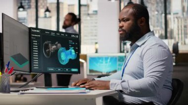 Ar-Ge çalışanı türbinler için sürdürülebilir materyalleri araştırıyor, rüzgar çiftliği planlarını optimize ediyor. Yenilenebilir enerji mühendisi yel değirmeni çiftliğini yeniliyor, temiz enerji çözümleri geliştiriliyor, kamera B