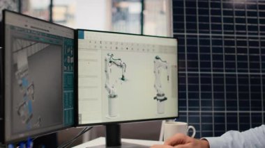 Ar-Ge araştırmacısı güneş yeşili enerji sistemlerini incelemek için belge dosyalarına bakıyor. Fotovoltaik karbon ayak izini geliştirmek için CAD yazılımı kullanan mühendis, kamera B