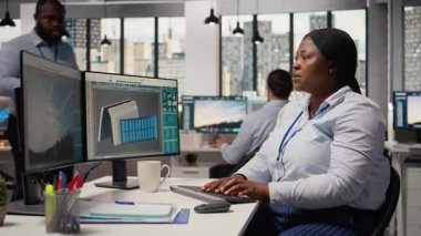 Ekip lideri, yenilikçi güneş enerjili cihaz prototipi üzerinde mühendis tarafından yapılan çalışmaları denetliyor. Ürün yöneticisi taşınabilir güneş paneli cihaz verimliliğini inceliyor Ar-Ge ofisinde, kamera A