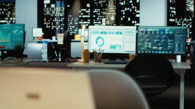 Geceleri boş şirket yönetim kurulu performans ölçümleri, grafikler ve projeksiyonların dijital görüntüleriyle parıldıyor. Çok uluslu bir şirkette modern çalışma alanı iş yönetimini yansıtır.