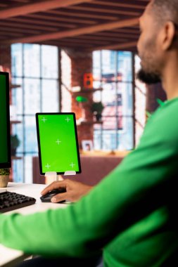 Çevrimiçi eğitim oturumuna katılarak yeşil ekran maket tableti kullanan uzaktan çalışan bir çalışan. Dairesinde telgraf işçisi krom anahtar aygıtı üzerine eğitim kursu videoları izliyor