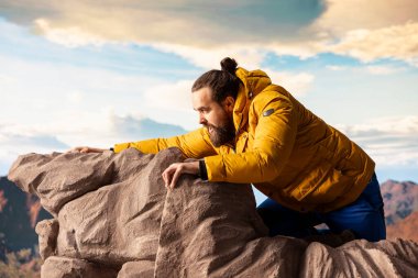 Pervasız, hazırlıksız yürüyüşçü yüksek irtifadaki bir uçurumun kenarına doğru tökezler ve güçlü rüzgarlar tarafından gafil avlanır. Sıradışı koşullar altında, dağın zirvesinde dengeyi kaybediyoruz..