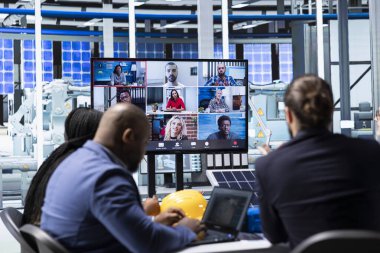 Güneş panelleri fabrika hissedarları telekonferans sırasında üretim süreçlerini nasıl geliştireceklerini tartışıyor. Fotovoltaik fabrikası yöneticisi çevrimiçi video görüşmesi sırasında güneş paneli otomasyon stratejisini sunar