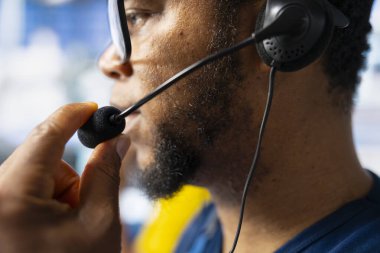 Siyah fabrika teknisyeni, güneş paneli çağrı merkezinden destek ve sorun giderme için yardım hattı taleplerini yönetmeyi teklif ediyor. Müşteri hizmetleri asistanı işlemleri geliştirir.