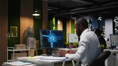 Ofis çalışanı AI analitik platformu ile aylık veri raporlarını kontrol ediyor, nöral ağ algoritmalarını gözden geçiriyor ve iş verimliliği için otomasyonu inceliyor. IT şirketi temsilcisi. Kamera A.