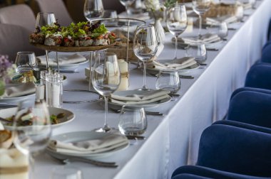 a table in a restaurant with dishes for a festive dinner and reception of guests