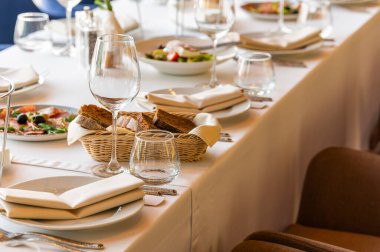 slicing fresh bread on a dining table plate, served table in a restaurant