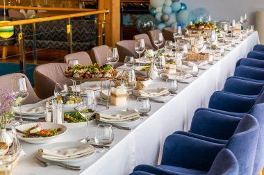 a table in a restaurant with dishes for a festive dinner and reception of guests