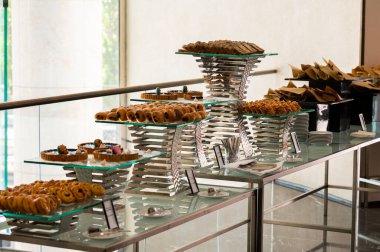 treats on metal supports on the catering table, fresh pastries
