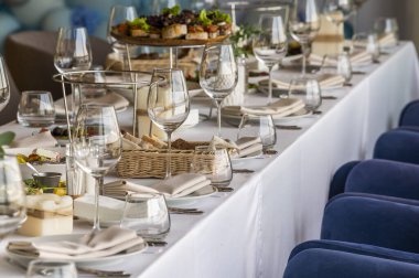 served table in a restaurant for receiving guests, serving dishes for visitors at a holiday at a large table