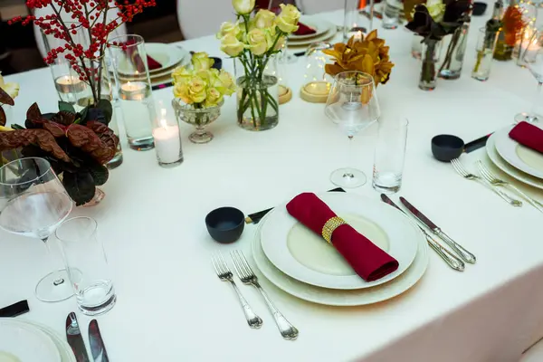 stock image decor of flowers on a served table with fabric napkins, serving for a reception in a restaurant