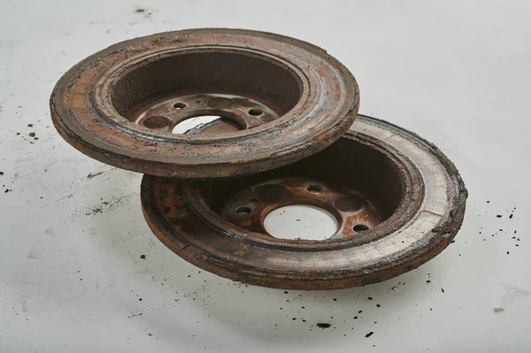 stock image Two rusty car brake discs taken from the car lie on a uniform light background