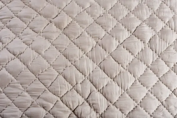warm quilted winter blanket and stitched fabric texture
