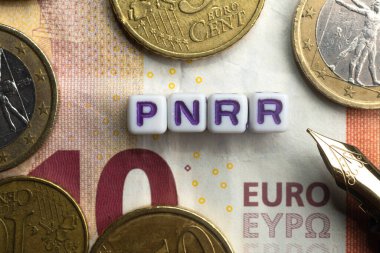 Pnrr (national recovery and resilience plan) concept: euro banknote and coins sorrounds the word pnnr clipart