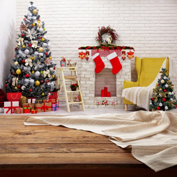 Empty white tablecloth on wooden desk perspective. Festive sparkling Christmas interiors background. Selective focus.