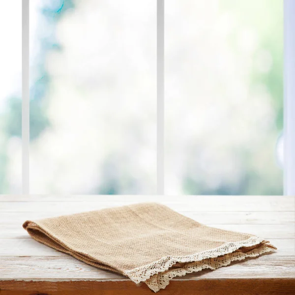 Rustic Chic: Wooden Table with a Napkin in Perspective. Canvas napkin with lace, tablecloth on wooden table on a sunny day. Can used for display or montage your products. Selective fokus