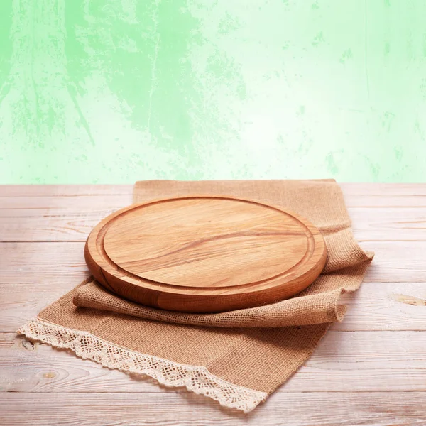 Satisfy your cravings in rustic chic style with our handcrafted wooden pizza board and napkin on wooden table. Nice pastel background top view mock up.