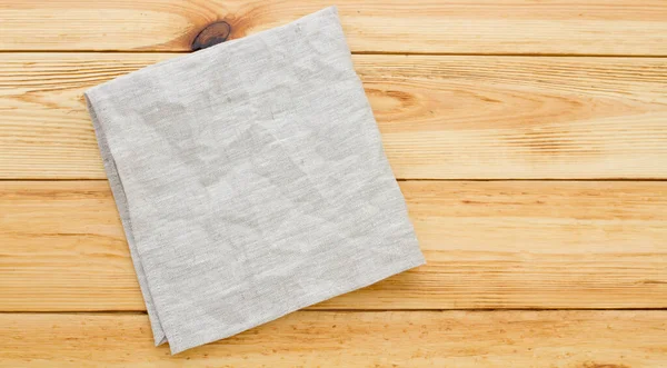 木制桌子特写纹理上的空白帆布餐巾纸顶部视图 — 图库照片